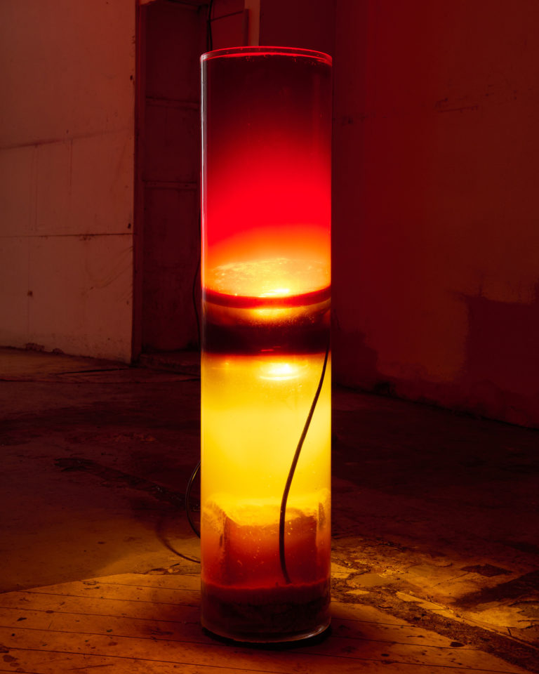 The Turkey Illusion, Wunderkammer, Lausanne, 2024. Waste cooking and motor oils, terrarium heating lamp, glass jars and demolished bricks, 20x100cm. © Sophie Ballmer, in collaboration with Tarik Hayward